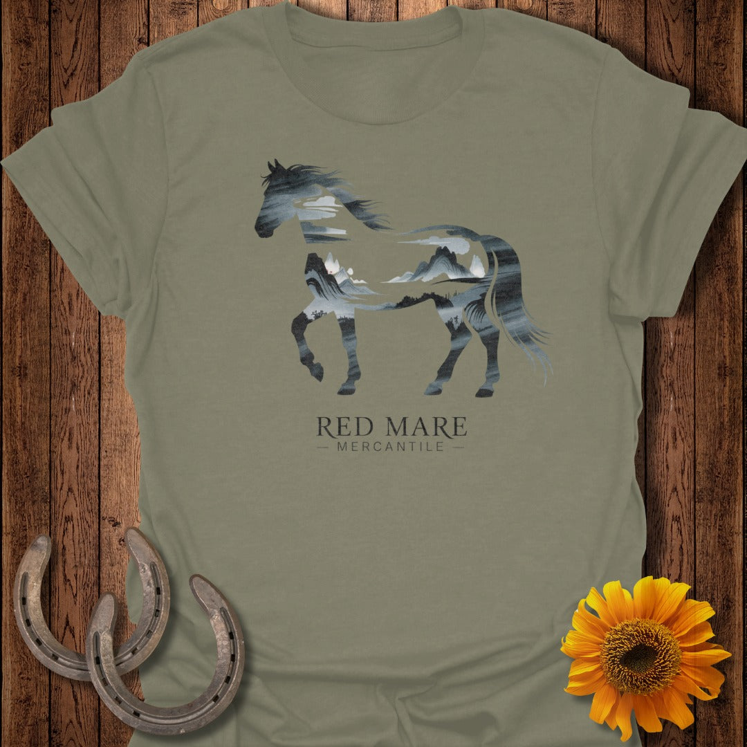 Olive green t-shirt with a silhouette of a horse filled with a mountain landscape.