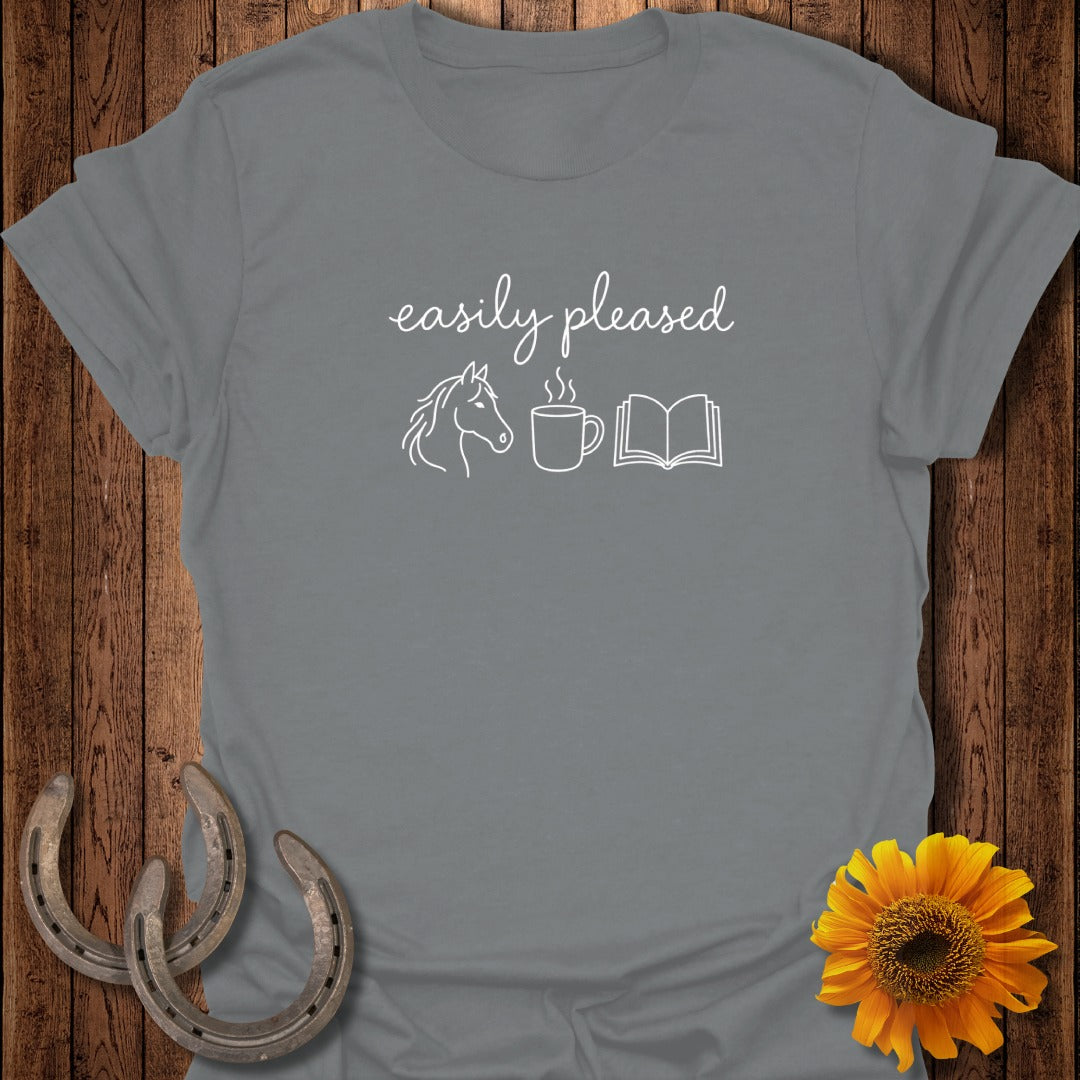 Gray short-sleeve t-shirt with the text "easily pleased" above line art of a horse head, coffee mug, and open book.