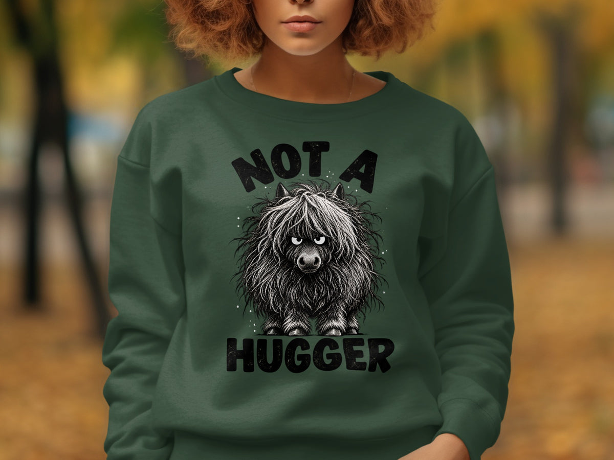 Dark green sweatshirt with a cartoon highland cow and text "NOT A HUGGER".