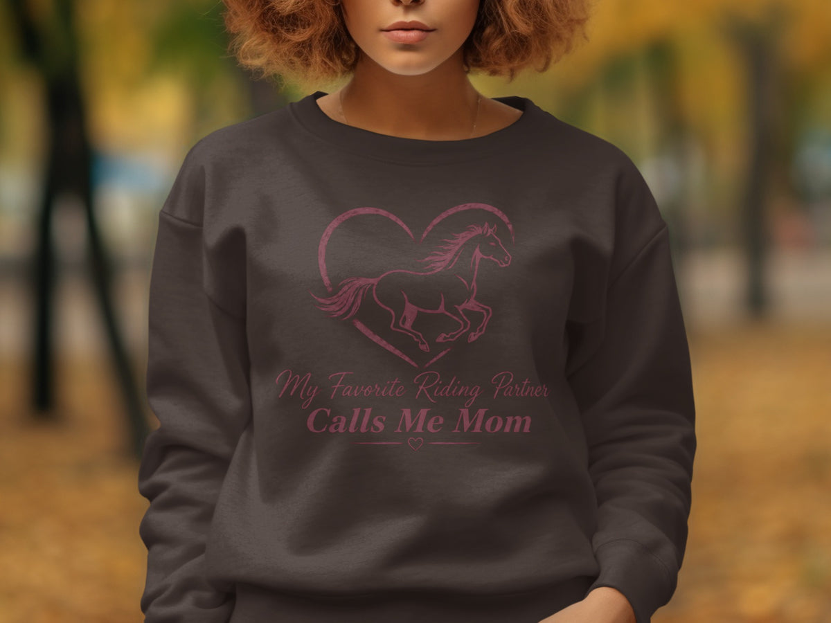 Dark sweatshirt with a pink heart, horse, and text "My Favorite Riding Partner Calls Me Mom".