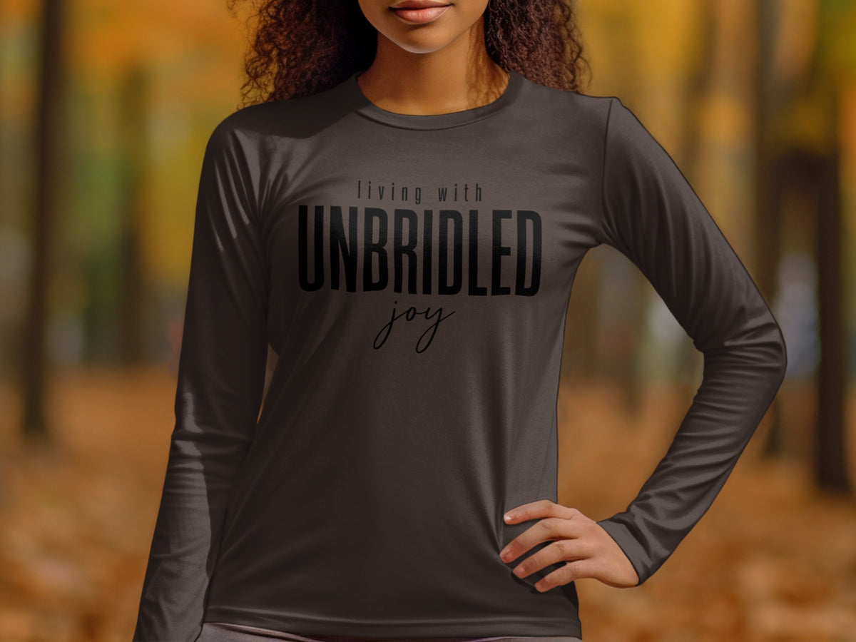 Dark long-sleeve shirt with "living with UNBRIDLED joy" text on front.