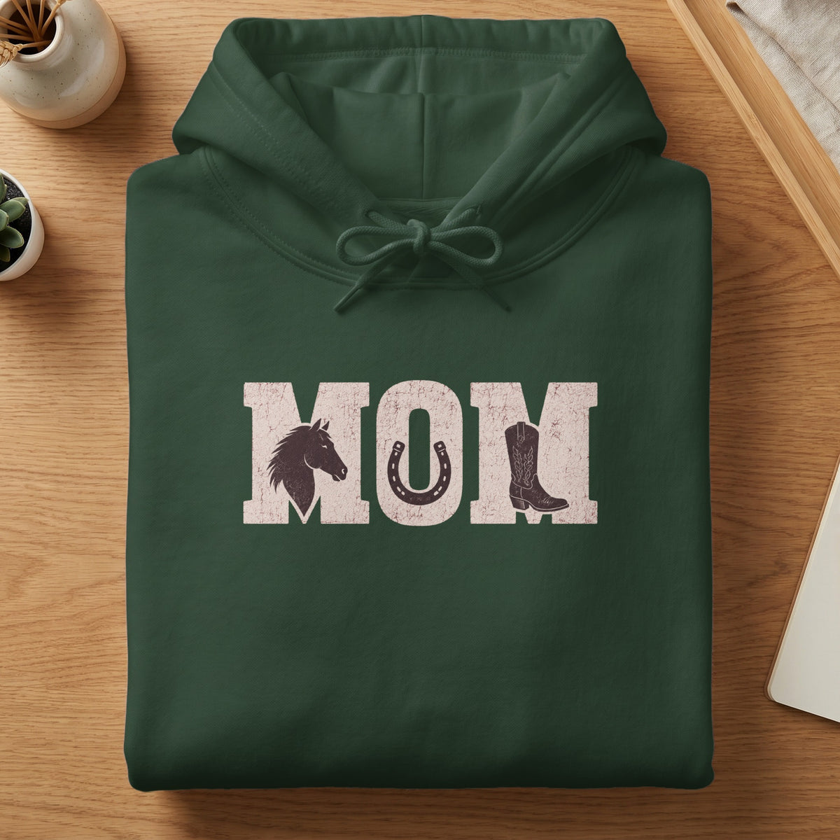 Green hoodie with distressed white text "MOM" featuring horse head, horseshoe, and cowboy boot.