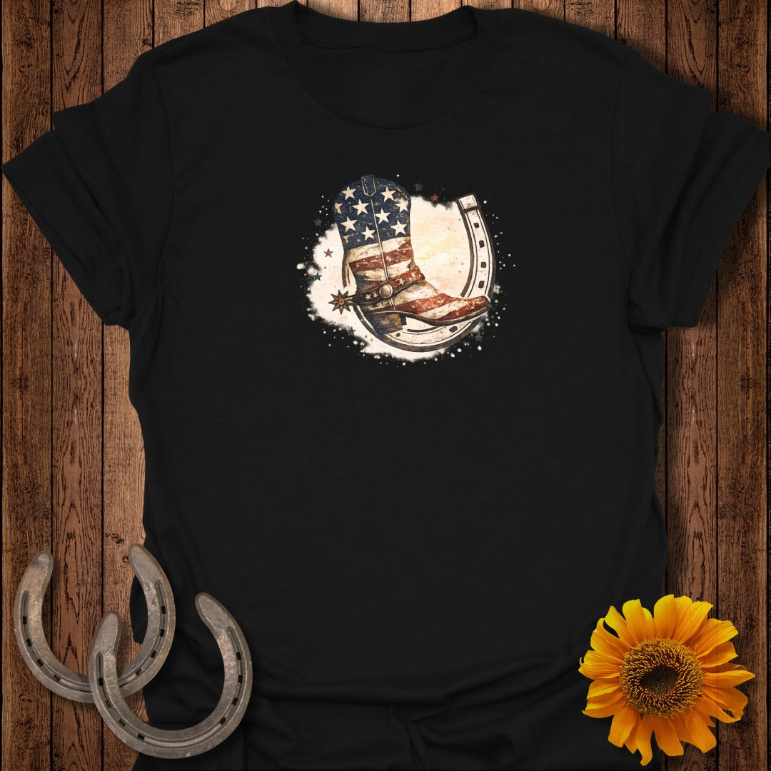 Cowboy boot with American flag and horseshoe graphic on black t-shirt.