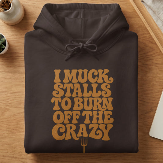 Dark brown hoodie with "I Muck Stalls To Burn Off The Crazy" text and a pitchfork.
