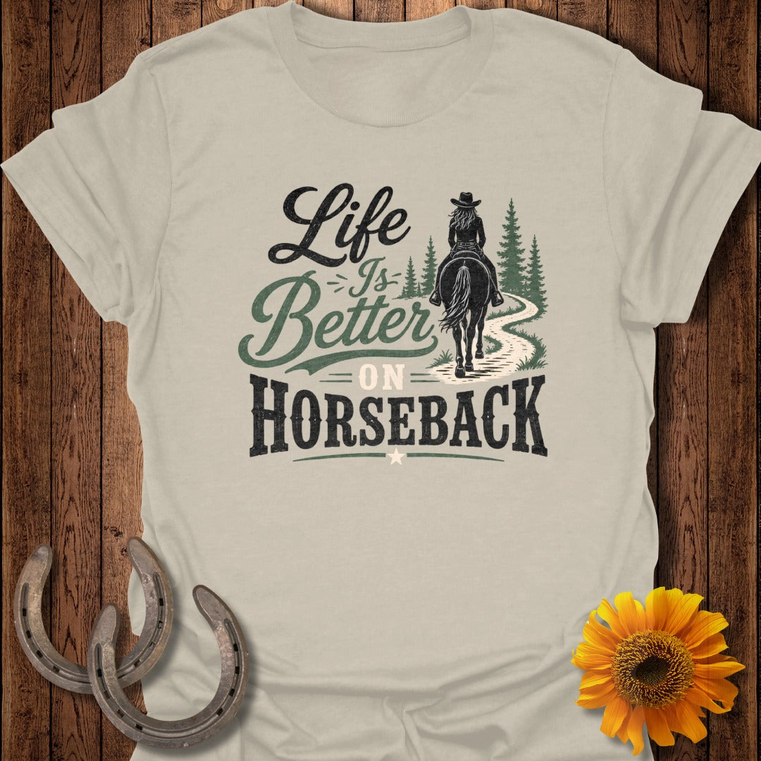 Light tan t-shirt with "Life Is Better On Horseback" text and horse rider silhouette.