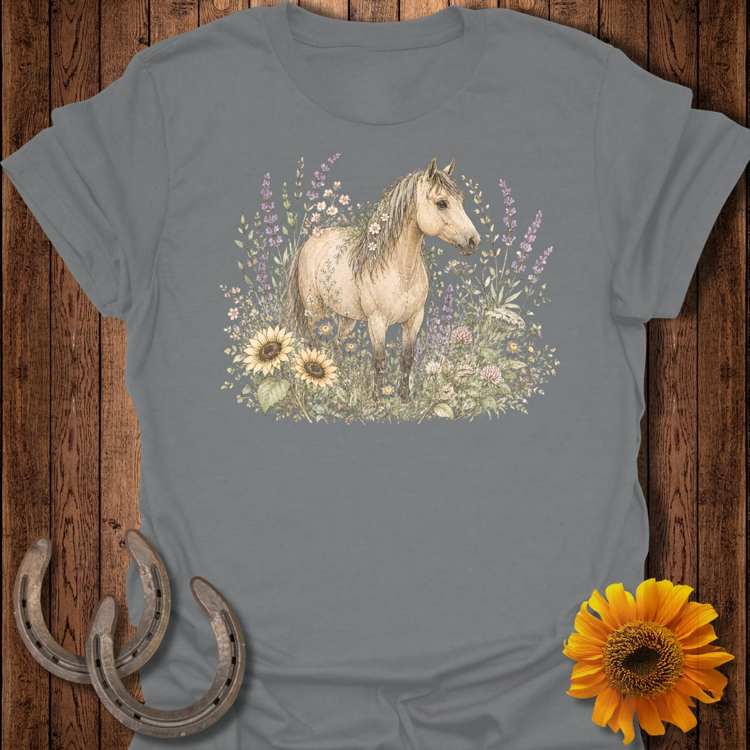 Grey t-shirt with a watercolor depiction of a light brown horse standing in wildflowers.