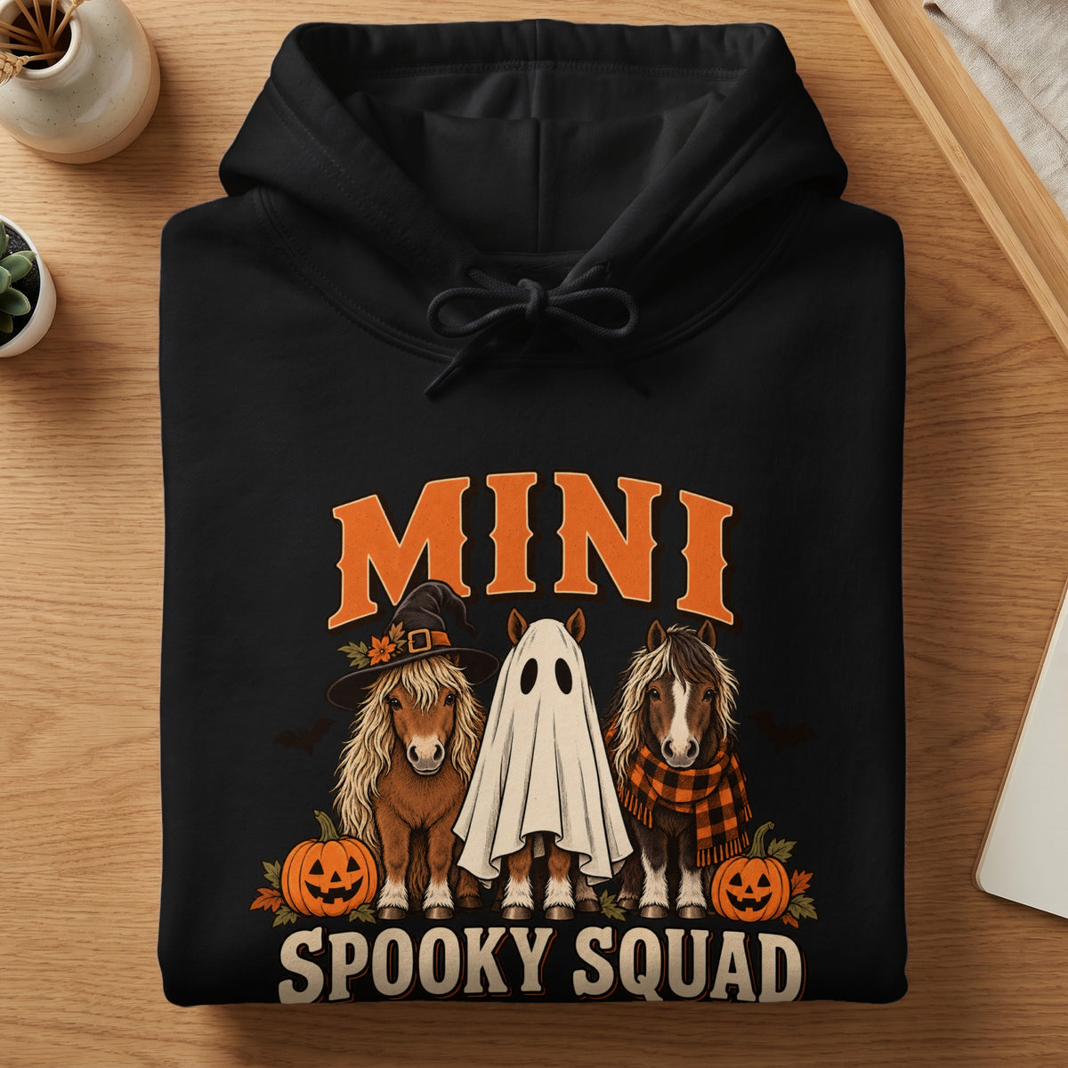 Black hoodie with mini horses dressed for Halloween, text "MINI SPOOKY SQUAD".
