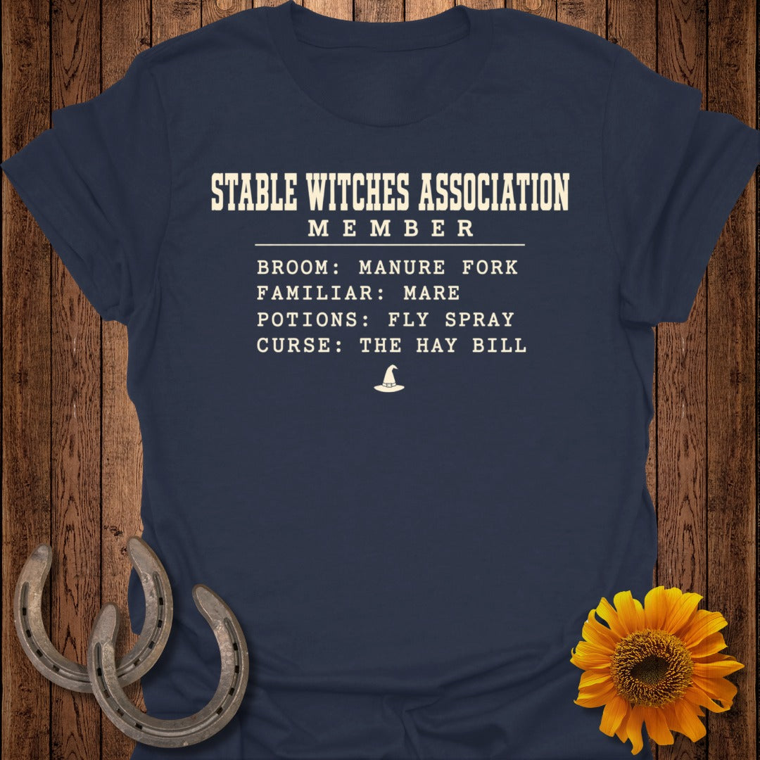 Navy t-shirt with "Stable Witches Association Member" text and witch hat graphic.
