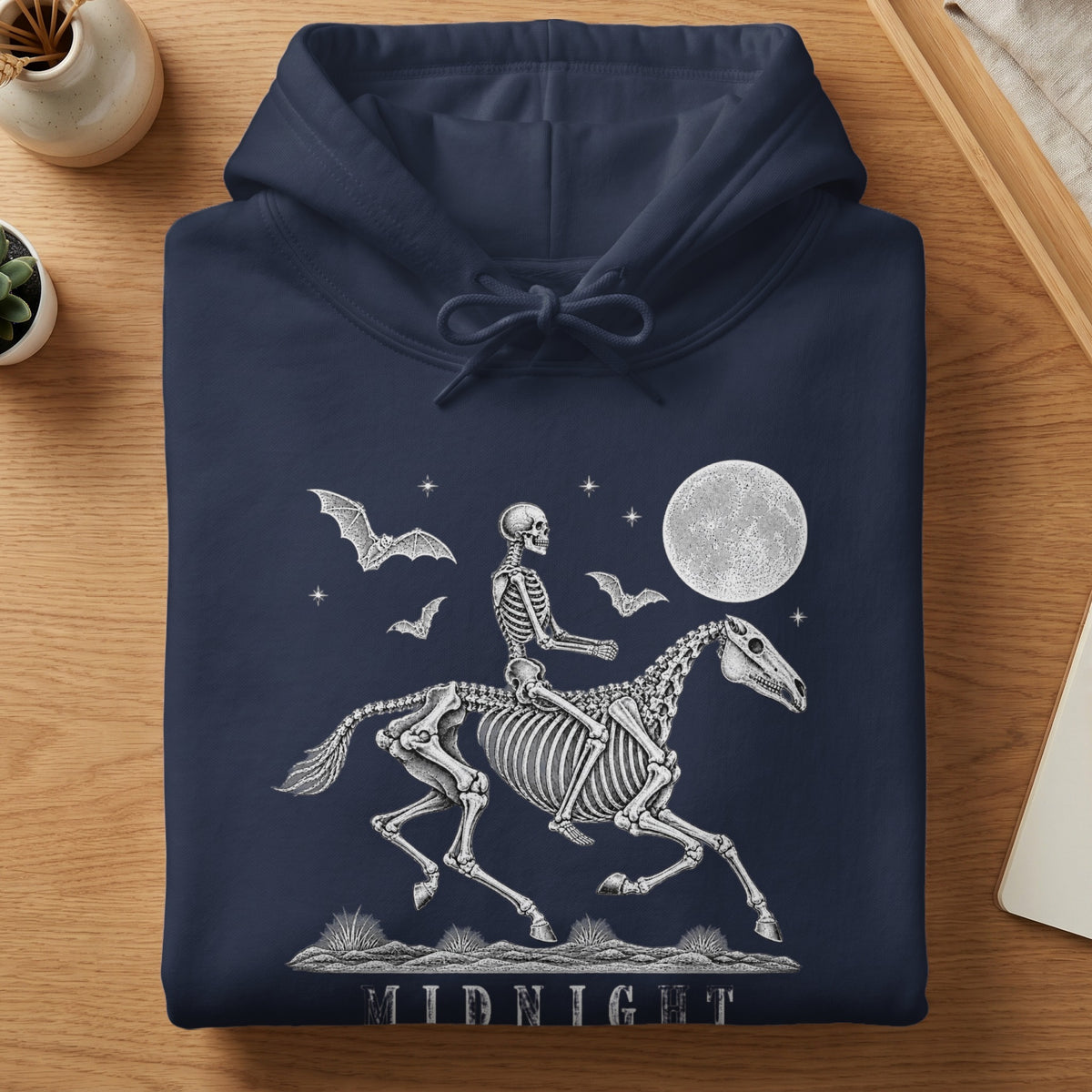 Skeleton riding a horse under a full moon with bats and the word MIDNIGHT.