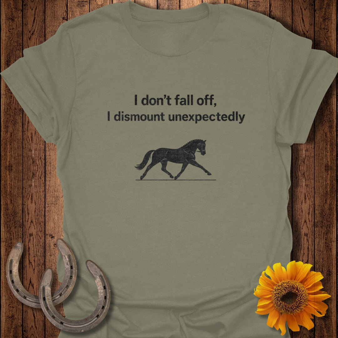 Olive t-shirt with text "I don't fall off, I dismount unexpectedly" and horse silhouette.