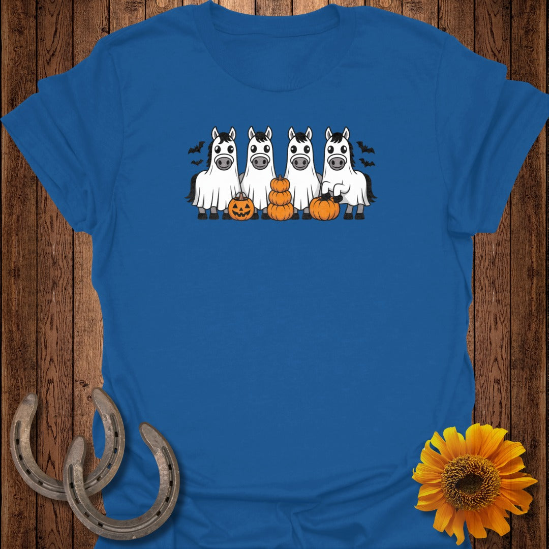 Four cartoon horses in ghost costumes with pumpkins and bats, on a blue t-shirt.