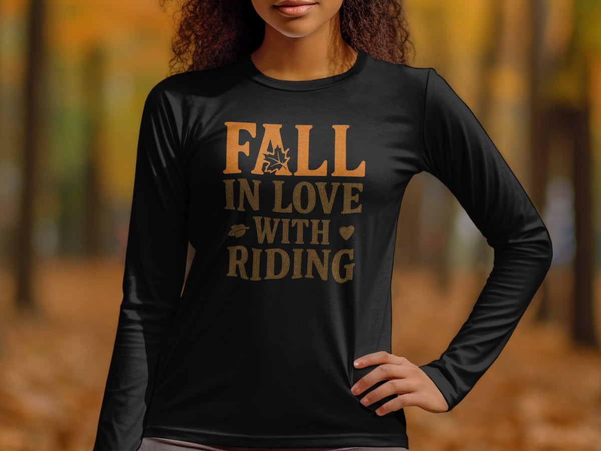 Black long-sleeve shirt with text "Fall in love with riding" and autumn leaf graphics.