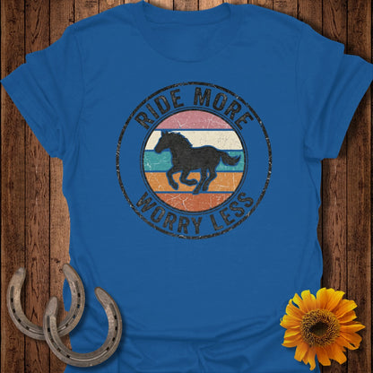 Blue t-shirt with circular graphic: "Ride More Worry Less" and a galloping horse silhouette.