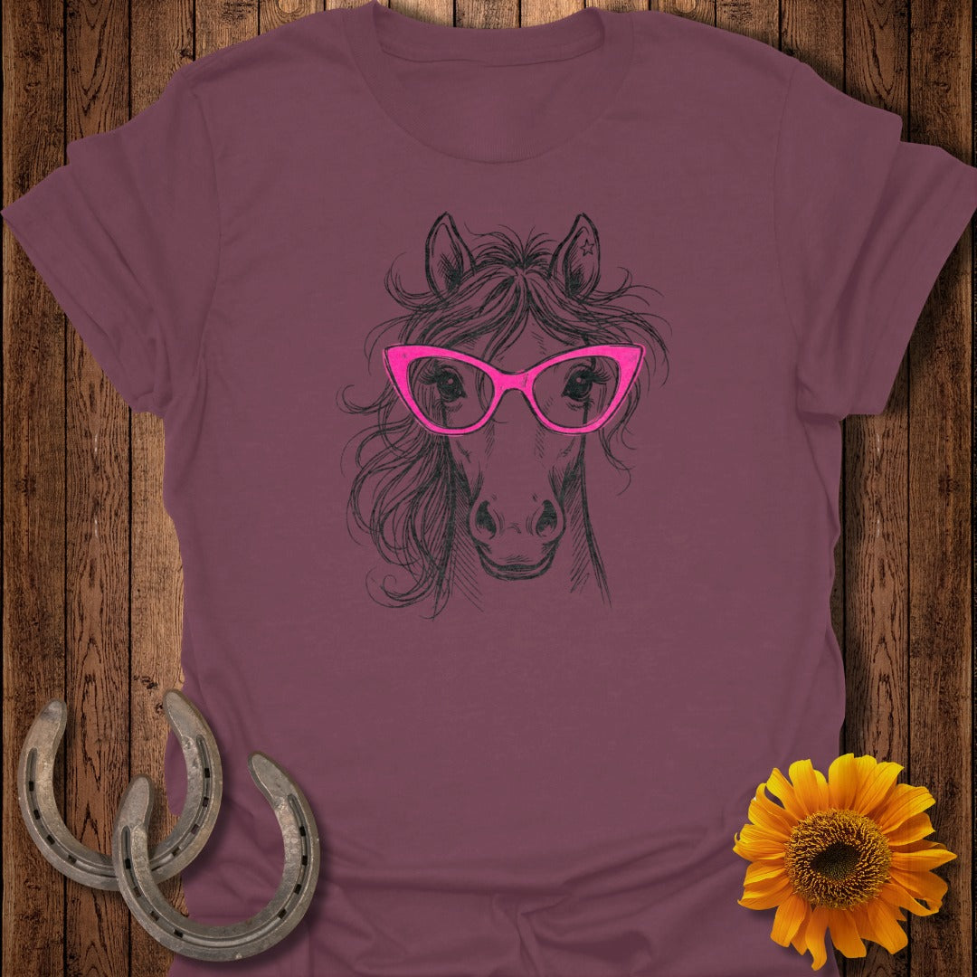 Line art horse wearing pink glasses on burgundy t-shirt.