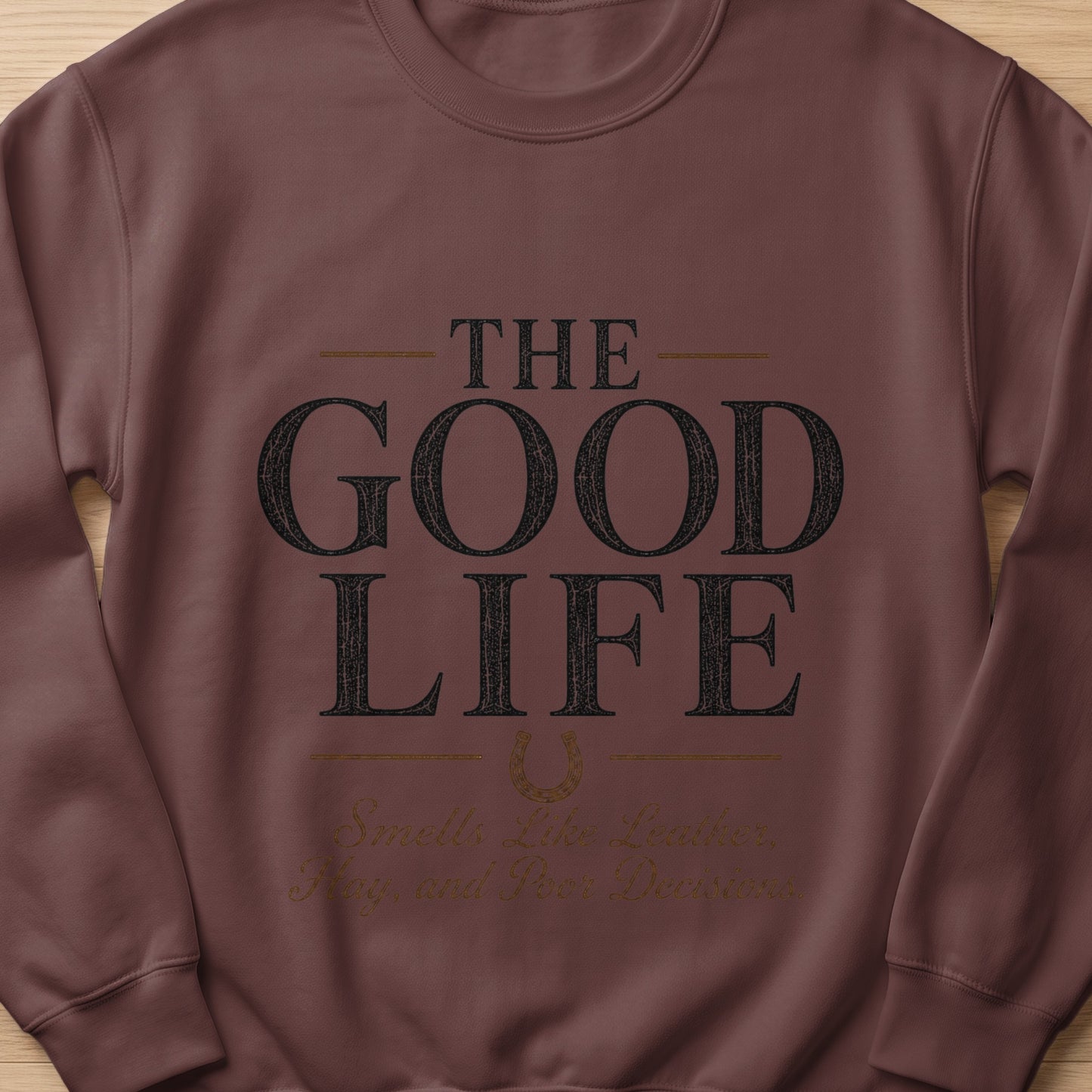 Brown sweatshirt with "The Good Life" and "Smells Like Leather, Hay, and Poor Decisions" text.