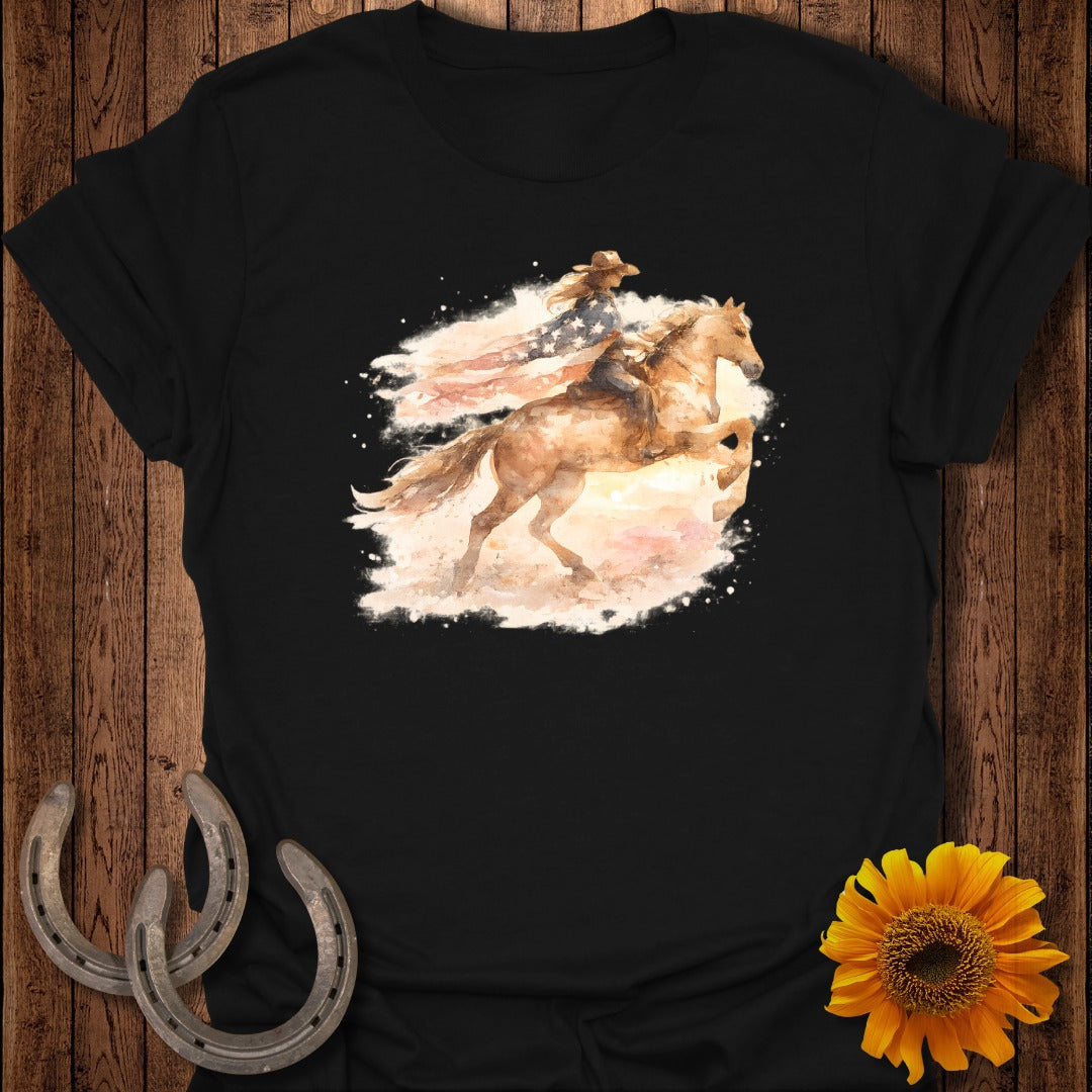 Cowgirl and horse silhouette with American flag watercolor graphic on black t-shirt.
