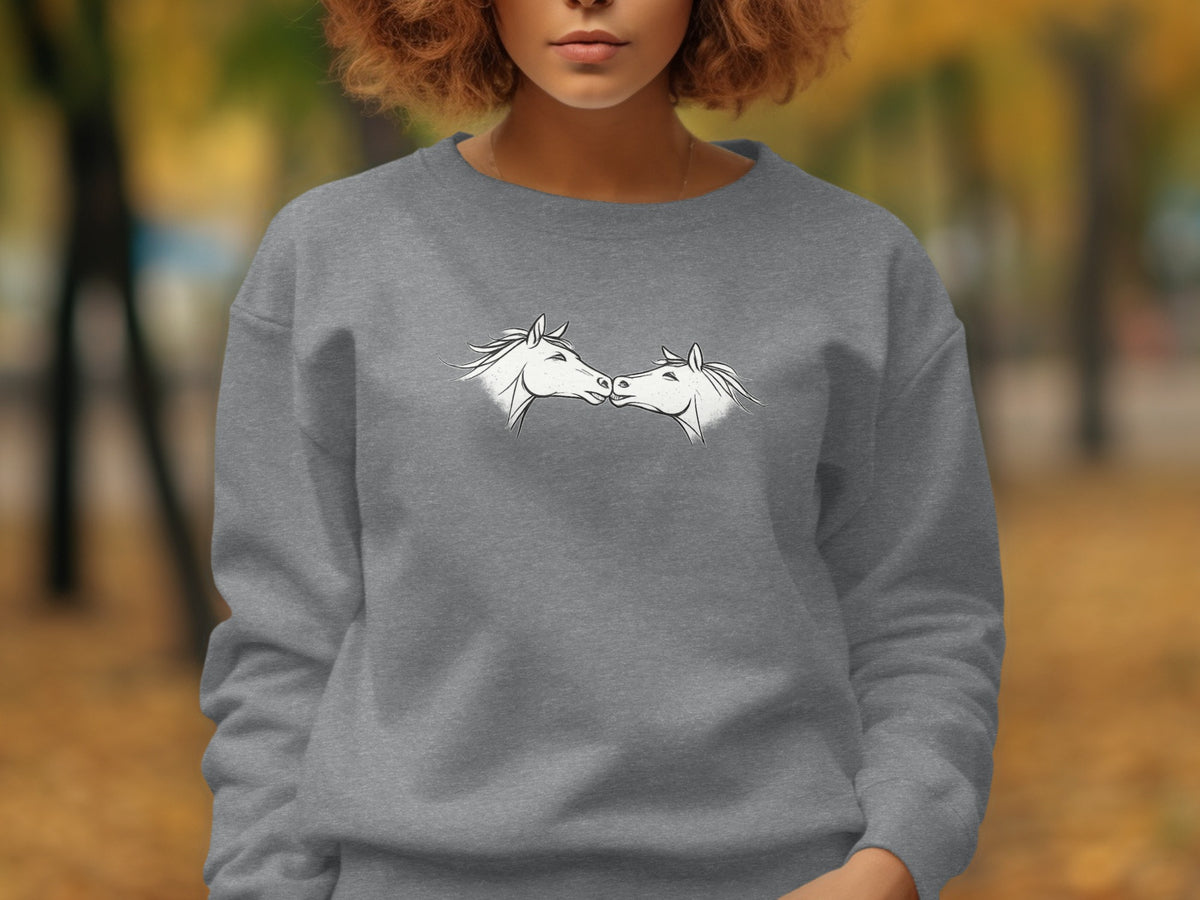 Grey sweatshirt with two white horse heads facing each other in a line drawing.