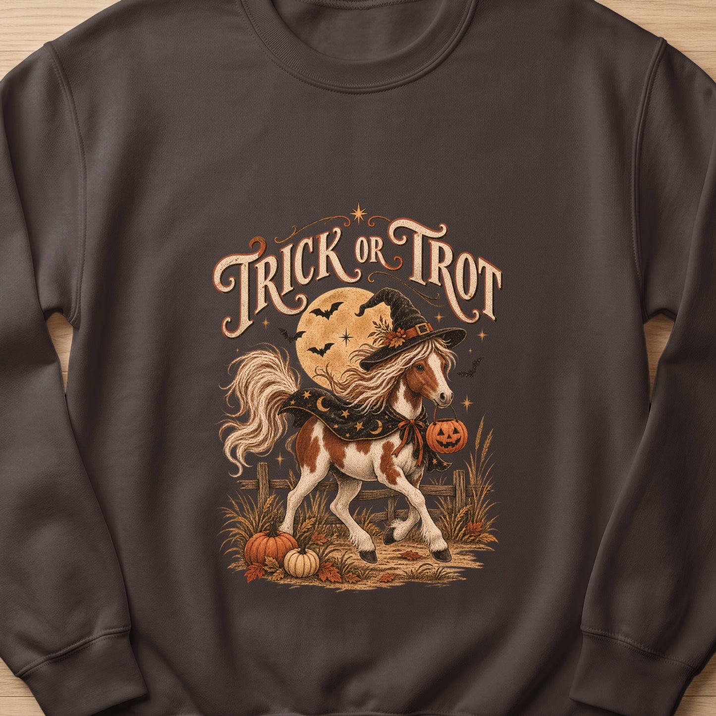 Pinto horse in witch hat carrying pumpkin bucket, text "Trick or Trot".