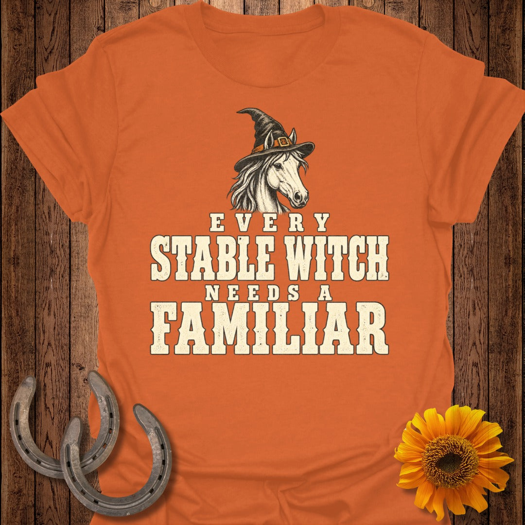 Orange t-shirt with horse wearing witch hat and text "EVERY STABLE WITCH NEEDS A FAMILIAR".