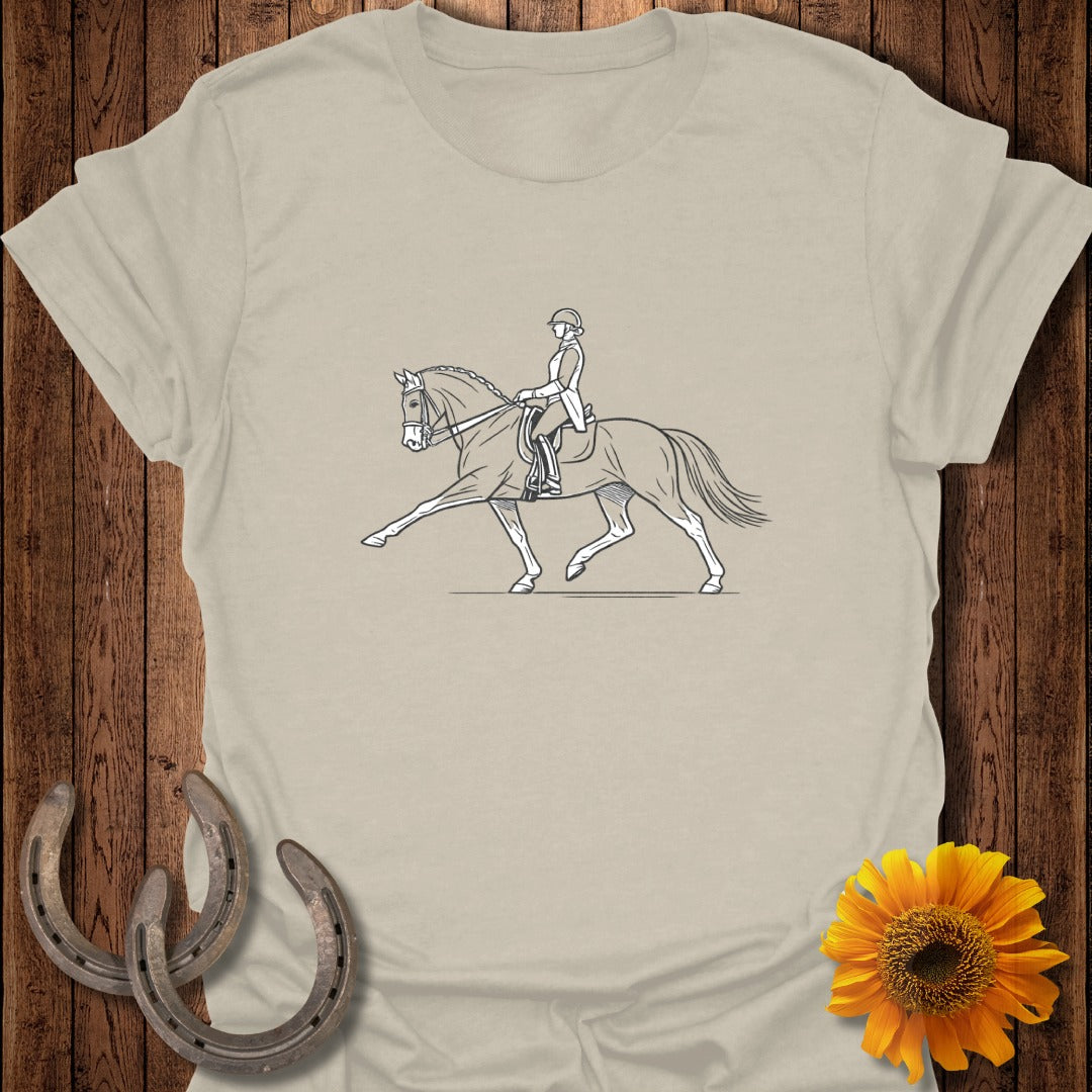 Light beige t-shirt with line drawing of a dressage rider on a horse.