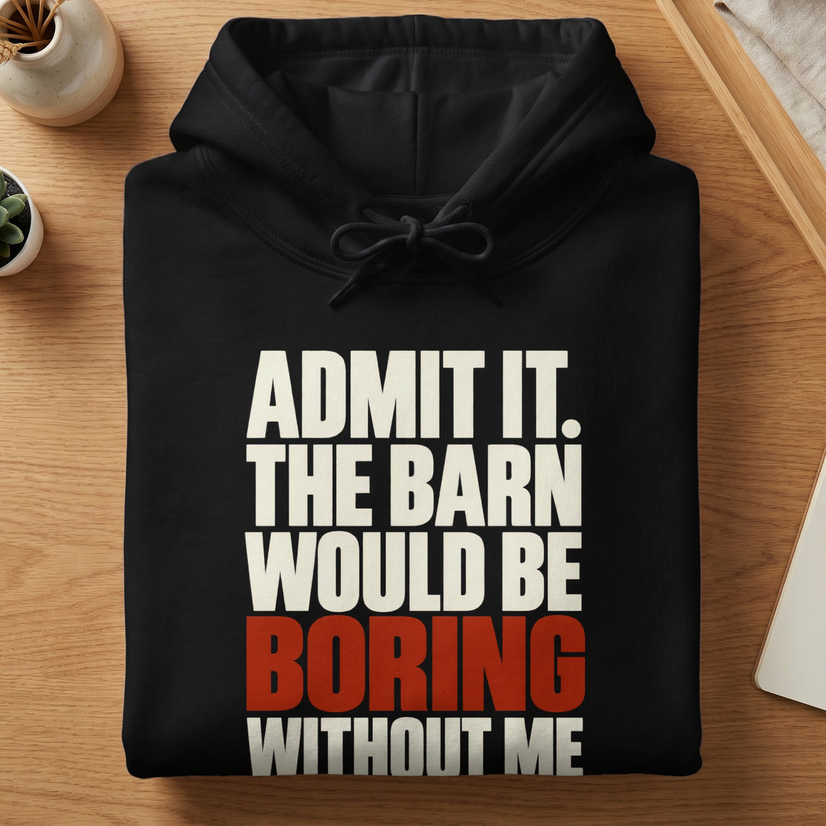 Folded black hoodie with white and red text reading ADMIT IT. THE BARN WOULD BE BORING WITHOUT ME.