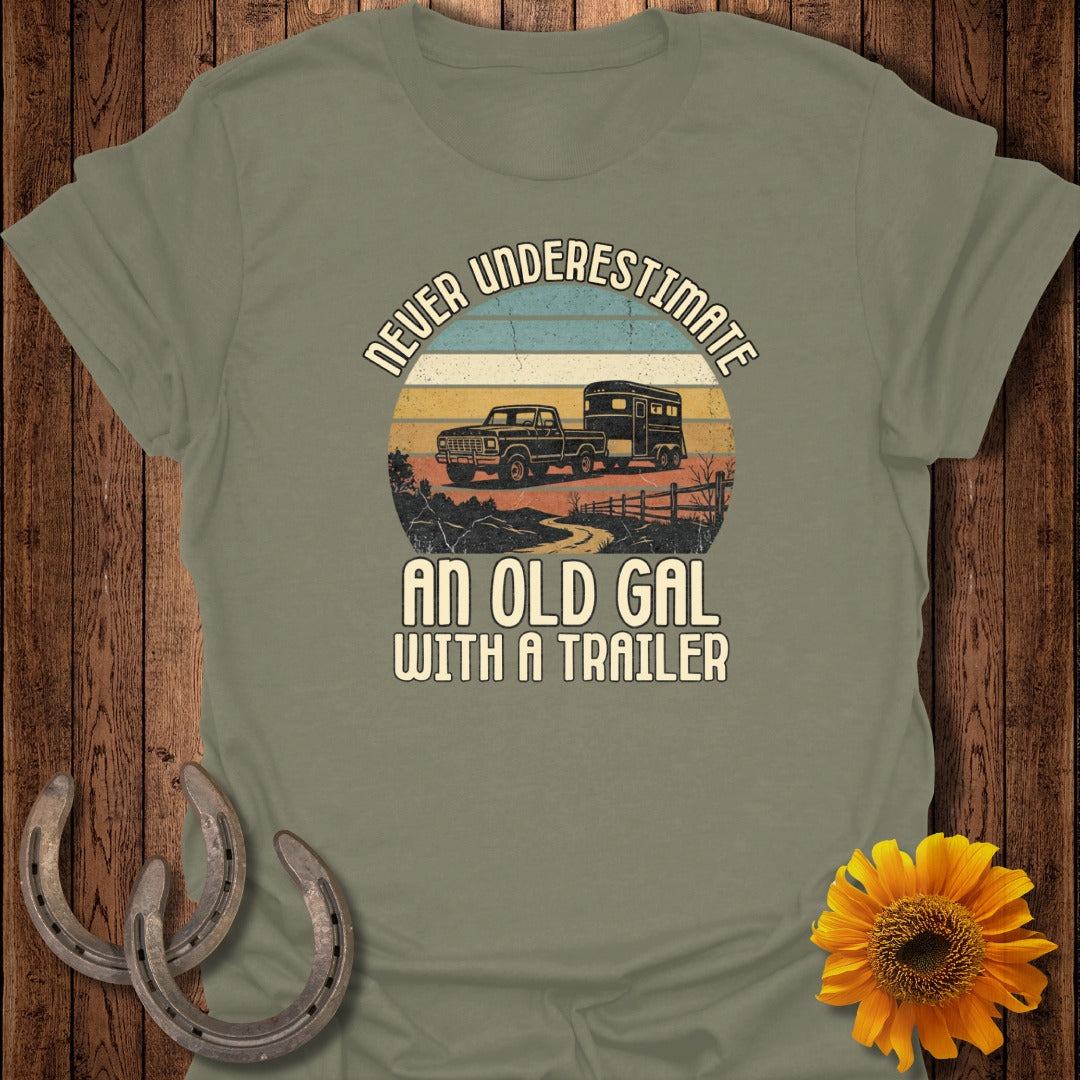 T-shirt with "Never Underestimate An Old Gal With A Trailer" text and truck with trailer graphic.