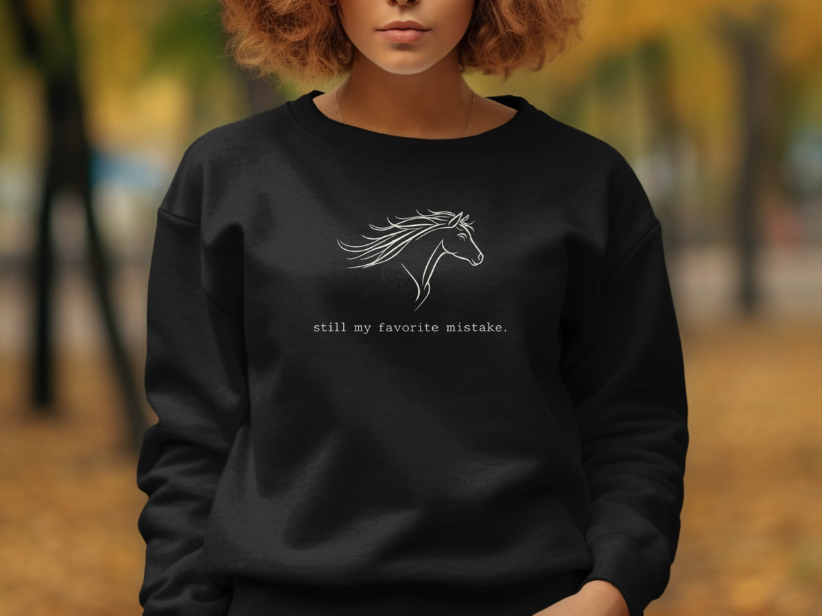 Black sweatshirt with white line art of a horse and text "still my favorite mistake."