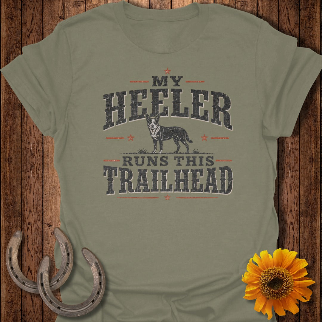Olive green t-shirt with "MY HEELER RUNS THIS TRAILHEAD" and a dog graphic.