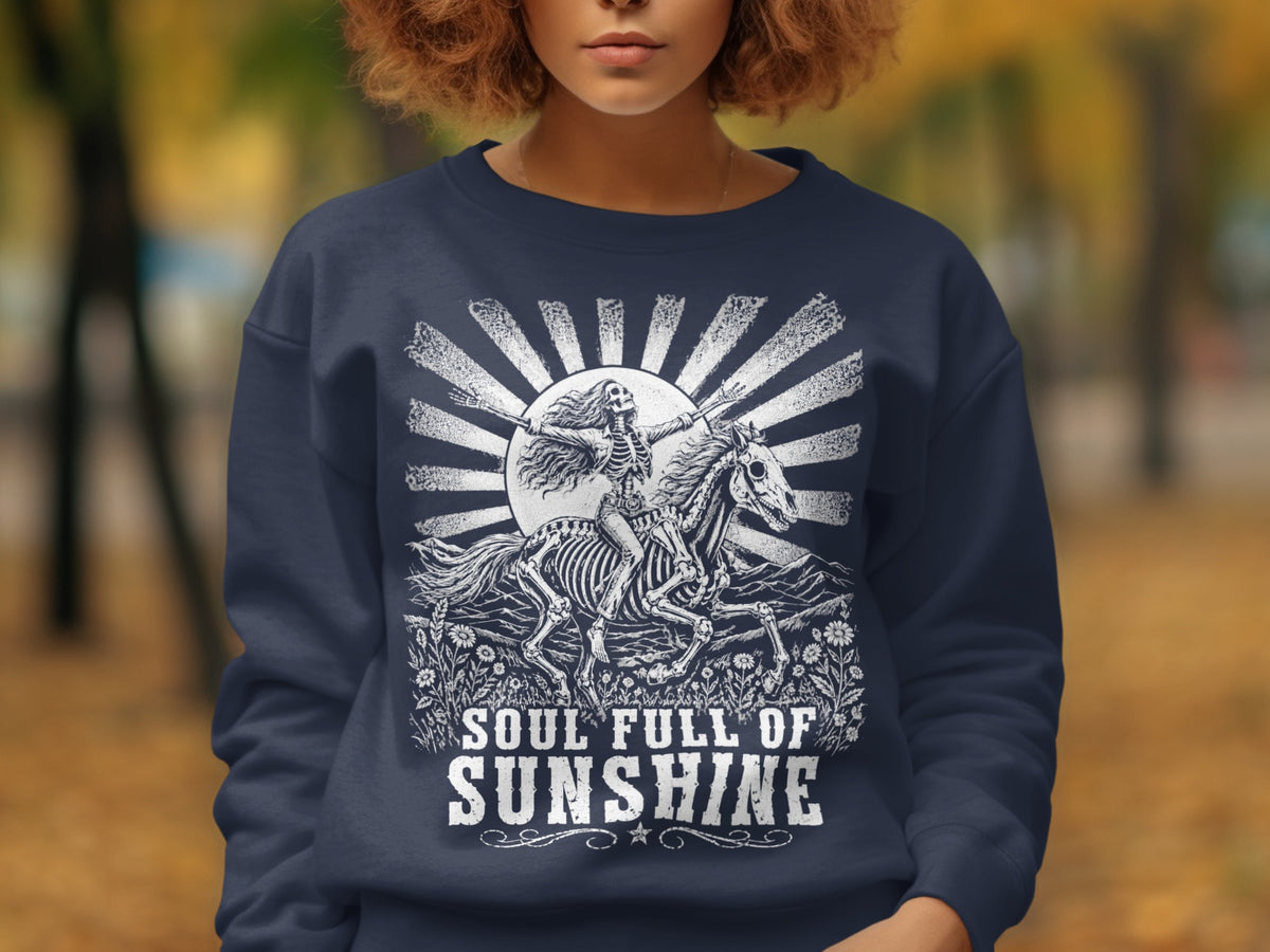 Skeleton riding horse with "Soul Full of Sunshine" text design on navy sweatshirt.