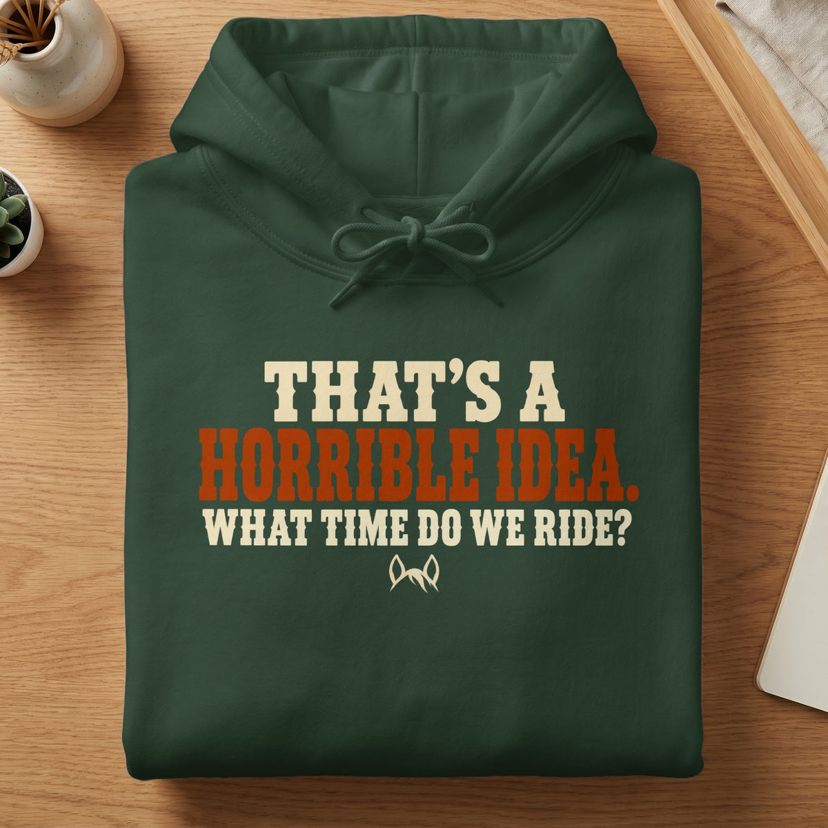 Green hoodie with text: "THAT'S A HORRIBLE IDEA. WHAT TIME DO WE RIDE?"