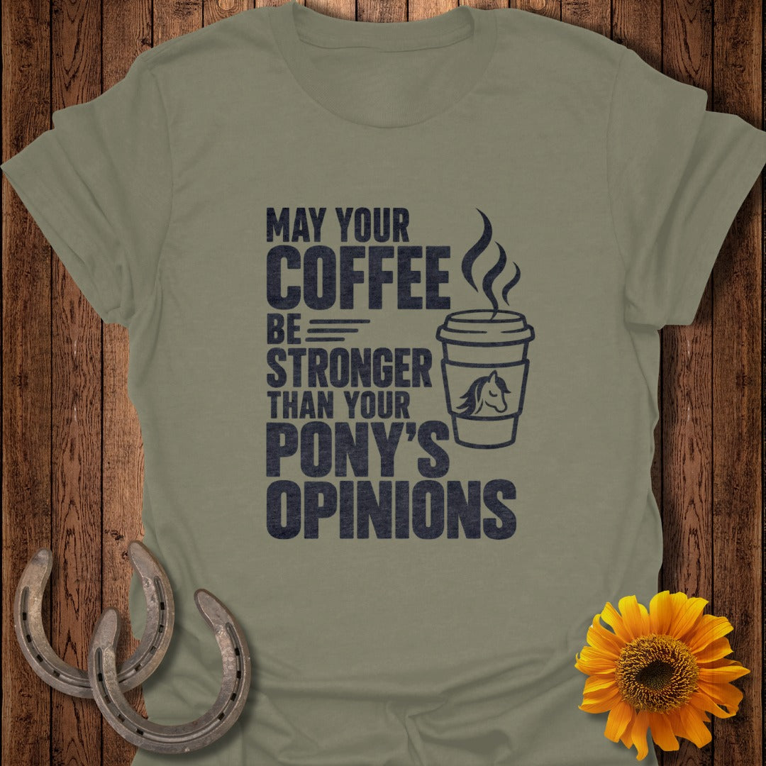 An olive green t-shirt featuring the text May Your Coffee Be Stronger Than Your Pony's Opinions next to a coffee cup graphic with a horse head emblem.