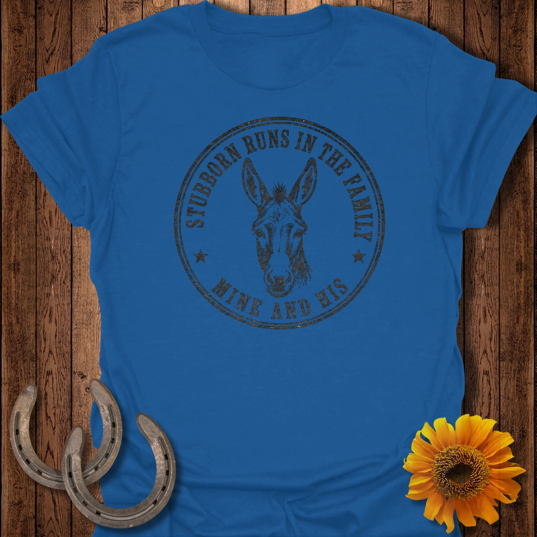 Blue t-shirt with a donkey's head and text that reads "Stubborn Runs in the Family Mine and His".