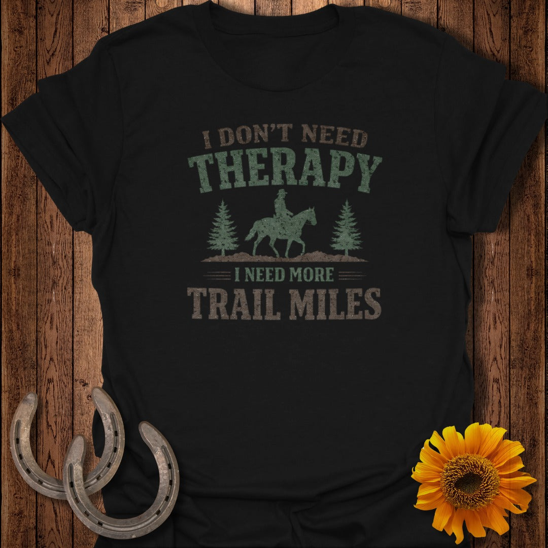 Black t-shirt with "I DON'T NEED THERAPY I NEED MORE TRAIL MILES" text.