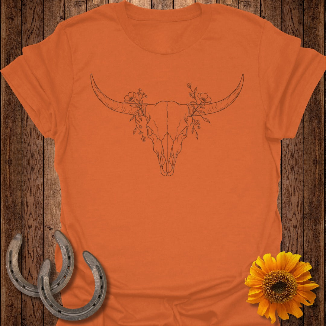 Orange t-shirt with a line drawing of a bull skull and floral accents.