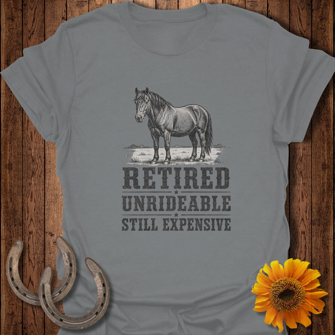 Gray t-shirt with drawing of horse and text "RETIRED UNRIDEABLE STILL EXPENSIVE".