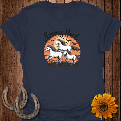 T-shirt with three white horses running against a sunset, with bats and the text "Spooky Herd."