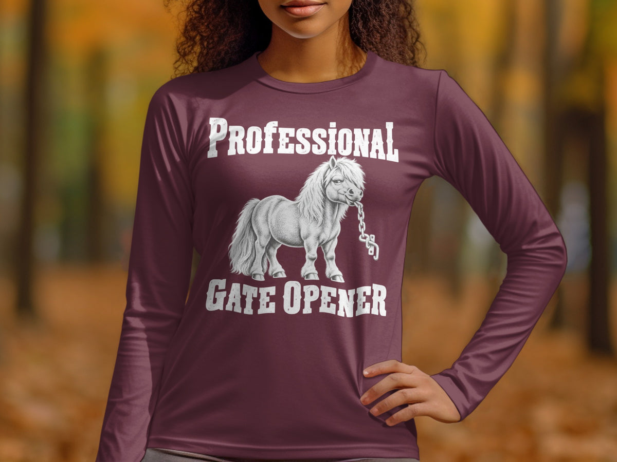 A person wearing a plum-colored long-sleeve shirt featuring white text reading Professional Gate Opener above and below an illustration of a pony biting a chain.