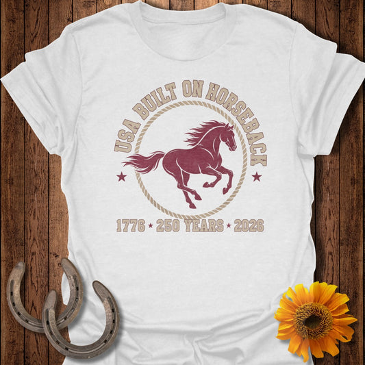 White t-shirt with maroon horse graphic and text USA BUILT ON HORSEBACK 1776 250 YEARS 2026.
