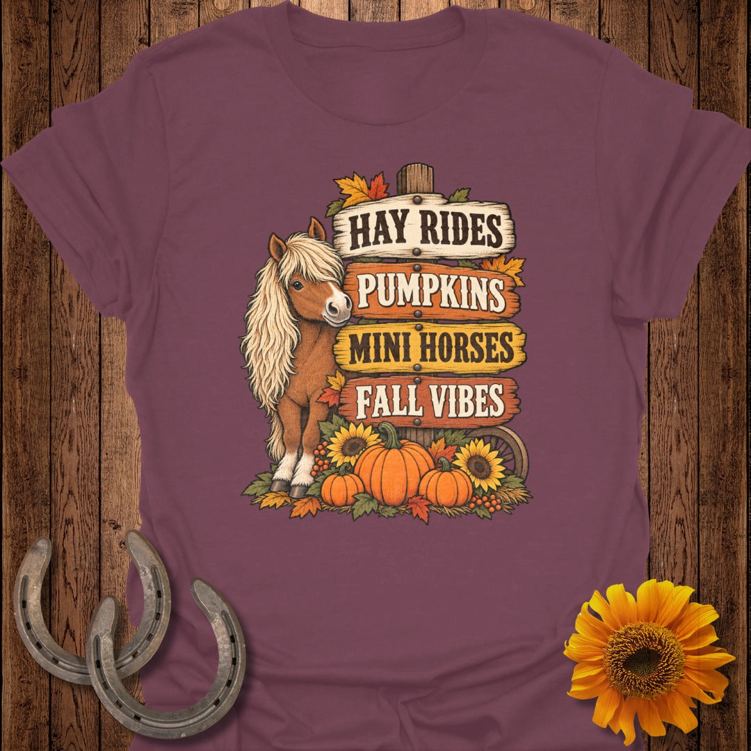 Mini horse with fall signs reading "Hay Rides, Pumpkins, Mini Horses, Fall Vibes."