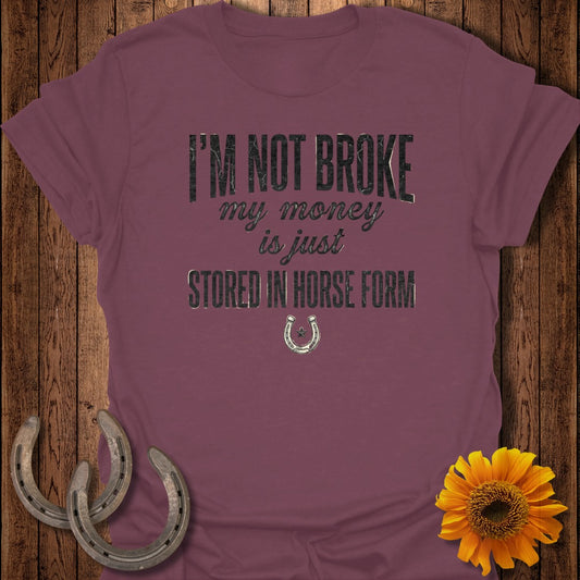 Burgundy t-shirt with "I'm not broke my money is just stored in horse form" text.