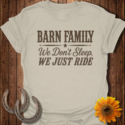 T-shirt with "Barn Family, We Don't Sleep, We Just Ride" text, two horseshoes, and a sunflower.