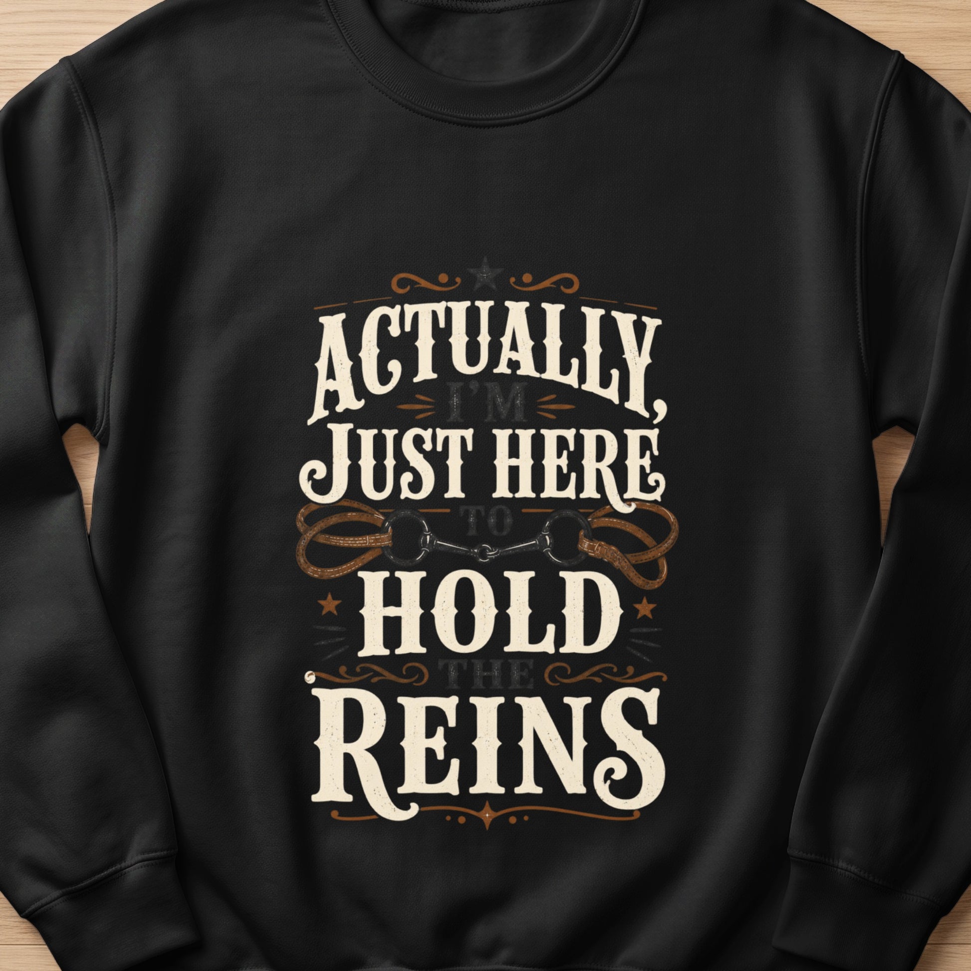 Black sweatshirt with text "Actually, I'm Just Here To Hold The Reins" and horse reins graphic.