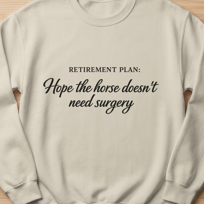 Light cream sweatshirt with "Retirement Plan: Hope the horse doesn't need surgery" text.