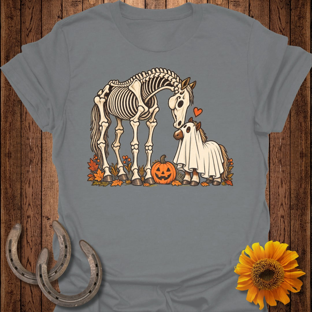 Skeleton horse and foal in ghost costume with pumpkin and autumn leaves.