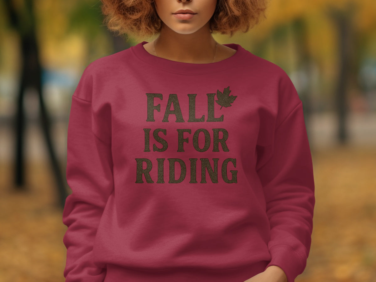 Maroon sweatshirt with text "FALL IS FOR RIDING" and a leaf graphic.