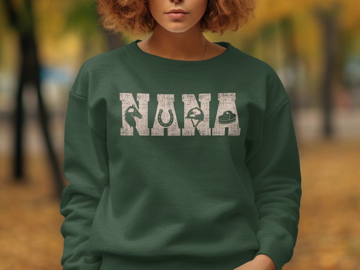 Green sweatshirt with white distressed "NANA" text and equestrian graphics.