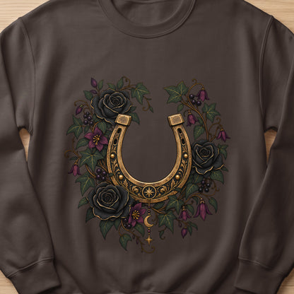 Gold horseshoe with black roses and ivy design on a brown sweatshirt.