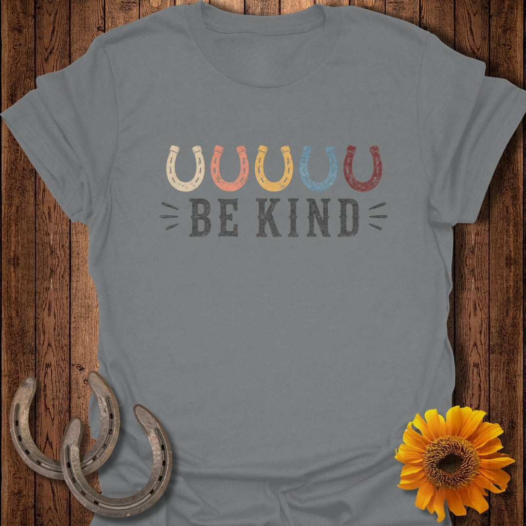 Grey t-shirt with colorful horseshoes and "BE KIND" text.