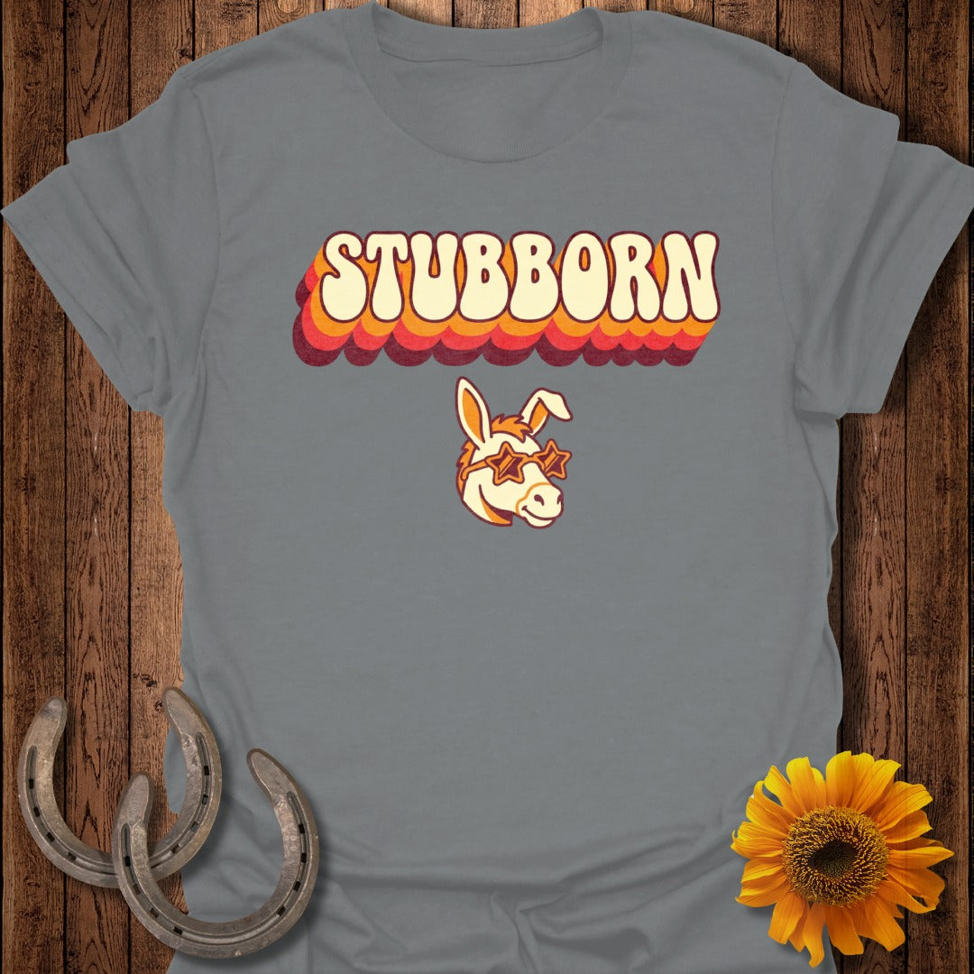 Gray t-shirt with "STUBBORN" in retro lettering and a donkey wearing sunglasses.