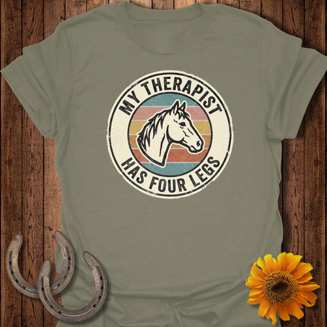 T-shirt with text "My therapist has four legs" and a horse head graphic.